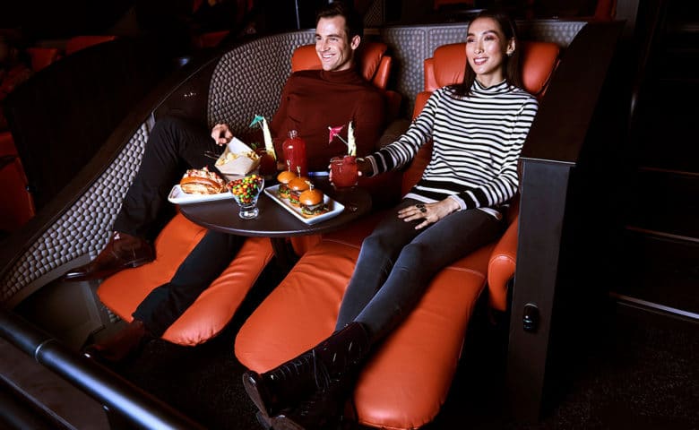 a couple enjoying a movie and food at IPIC