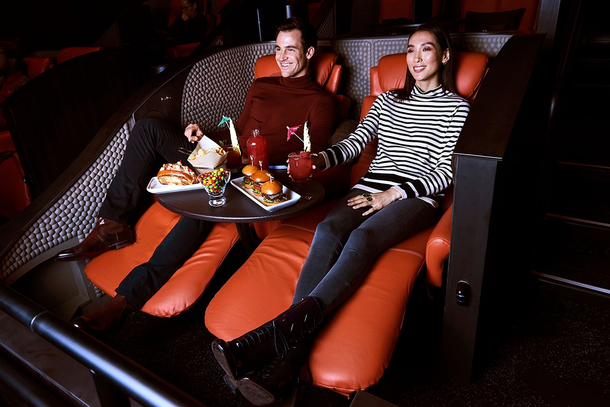 a couple enjoying a movie and food at IPIC