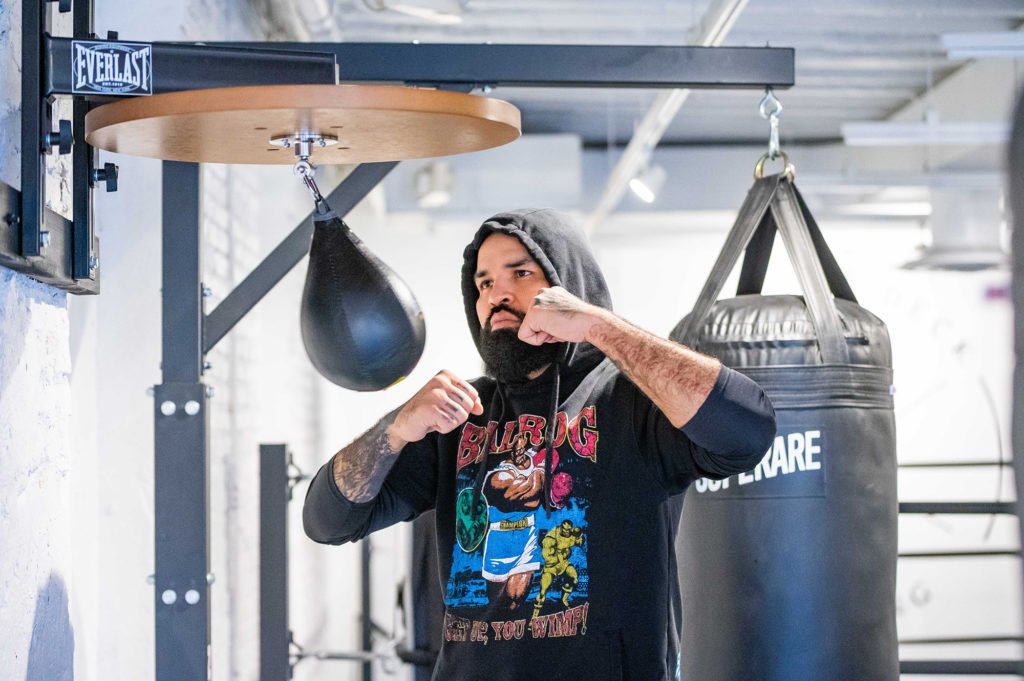 Stephen Frank of HIIT The Deck punching a punching bag