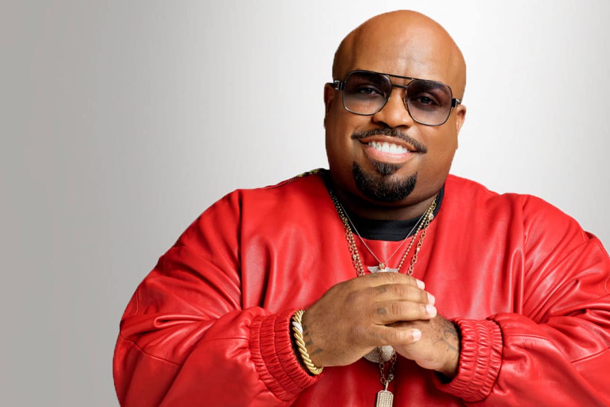 CeeLo Green in sunglasses, a red sweatshirt, and gold chains