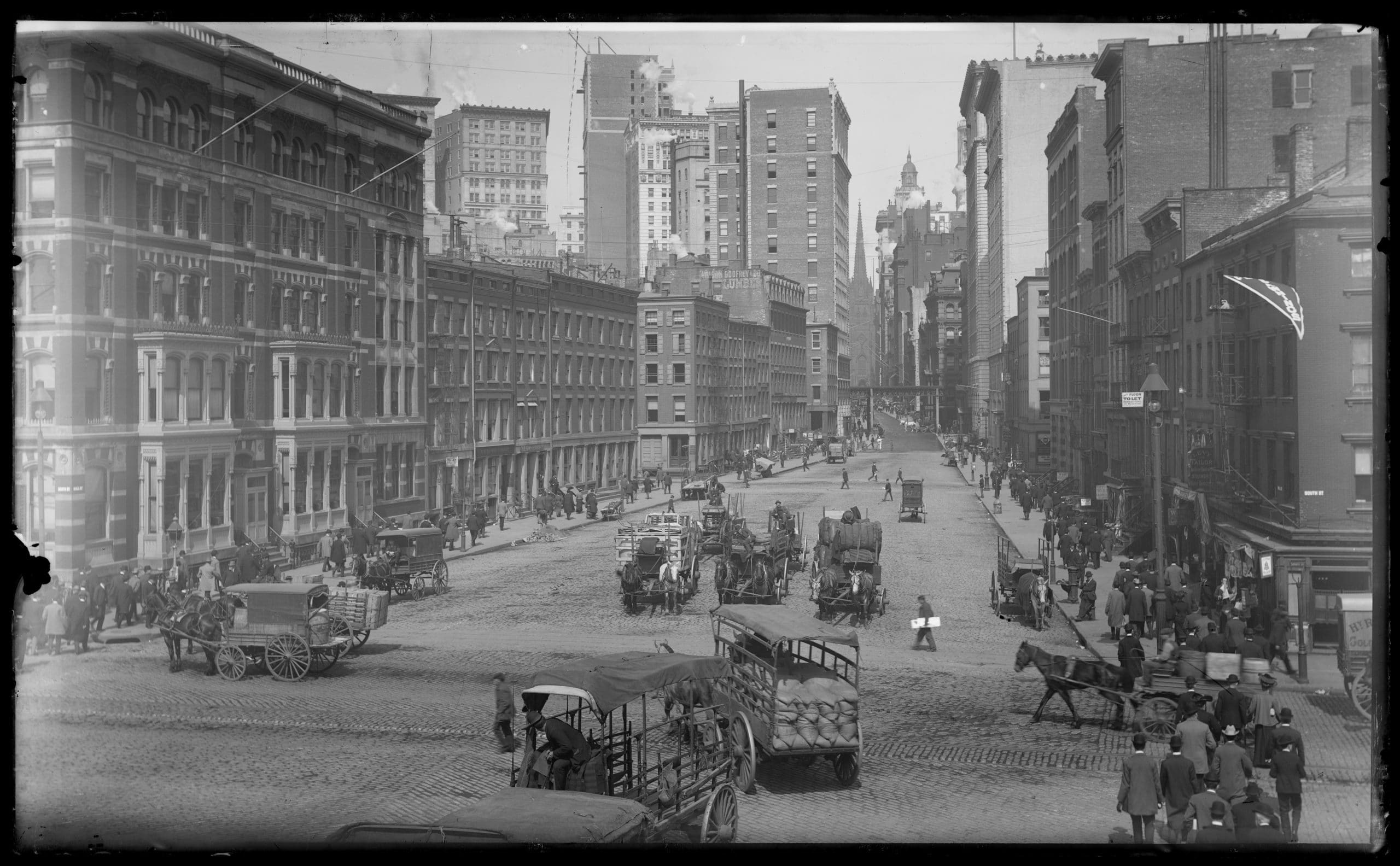 black and white photo of horse-drawn carriages in the Seaport