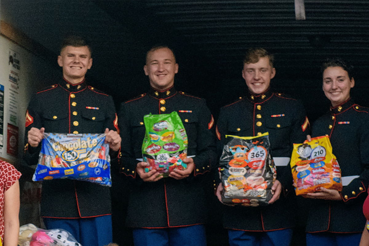 Marines holding donated bags of candy through Operation Gratitude