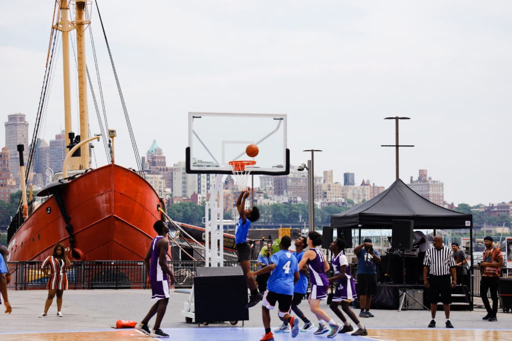 People playing basketball on the Seaport Court at Pier 17