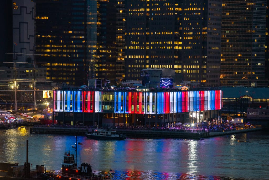 Pier 17 lit up in red, white, and blue for Fourth of July