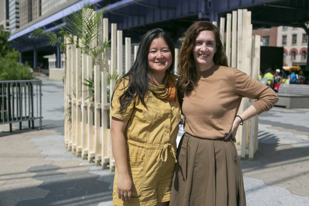 artists standing in front of wood river lab structure