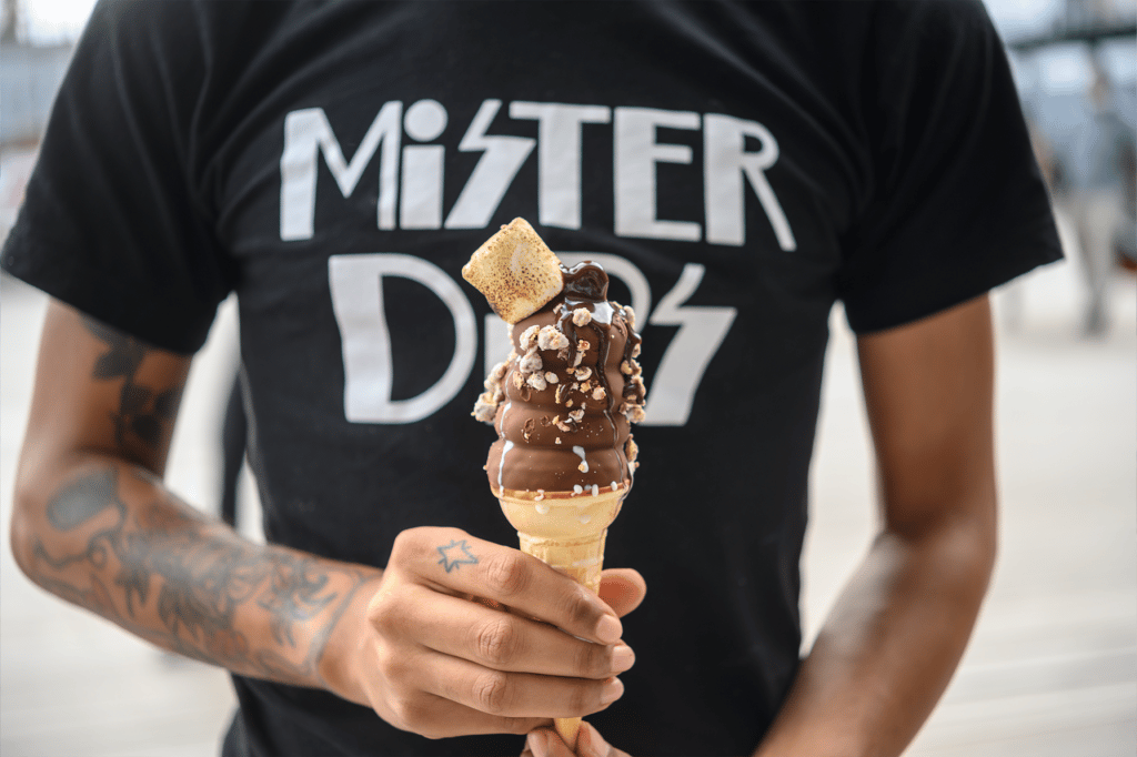 a person holding a Mister Dips s'mores ice cream cone