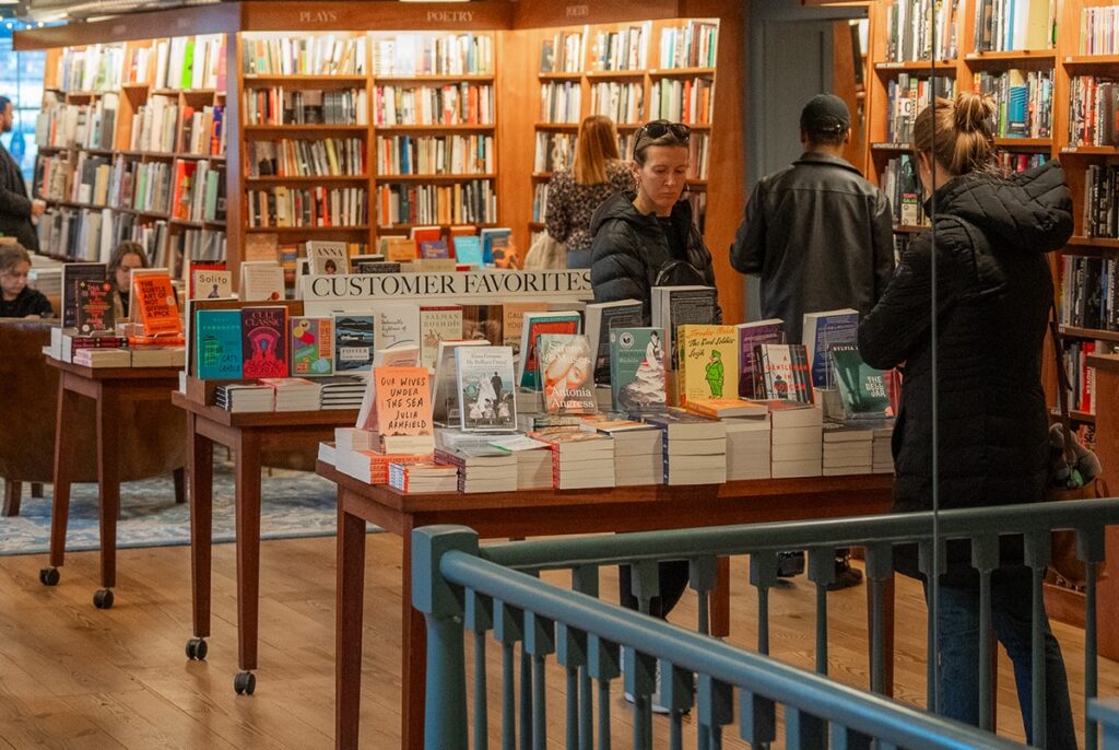 a group of customers shop for books at the mcnally jackson bookstore at the seaport