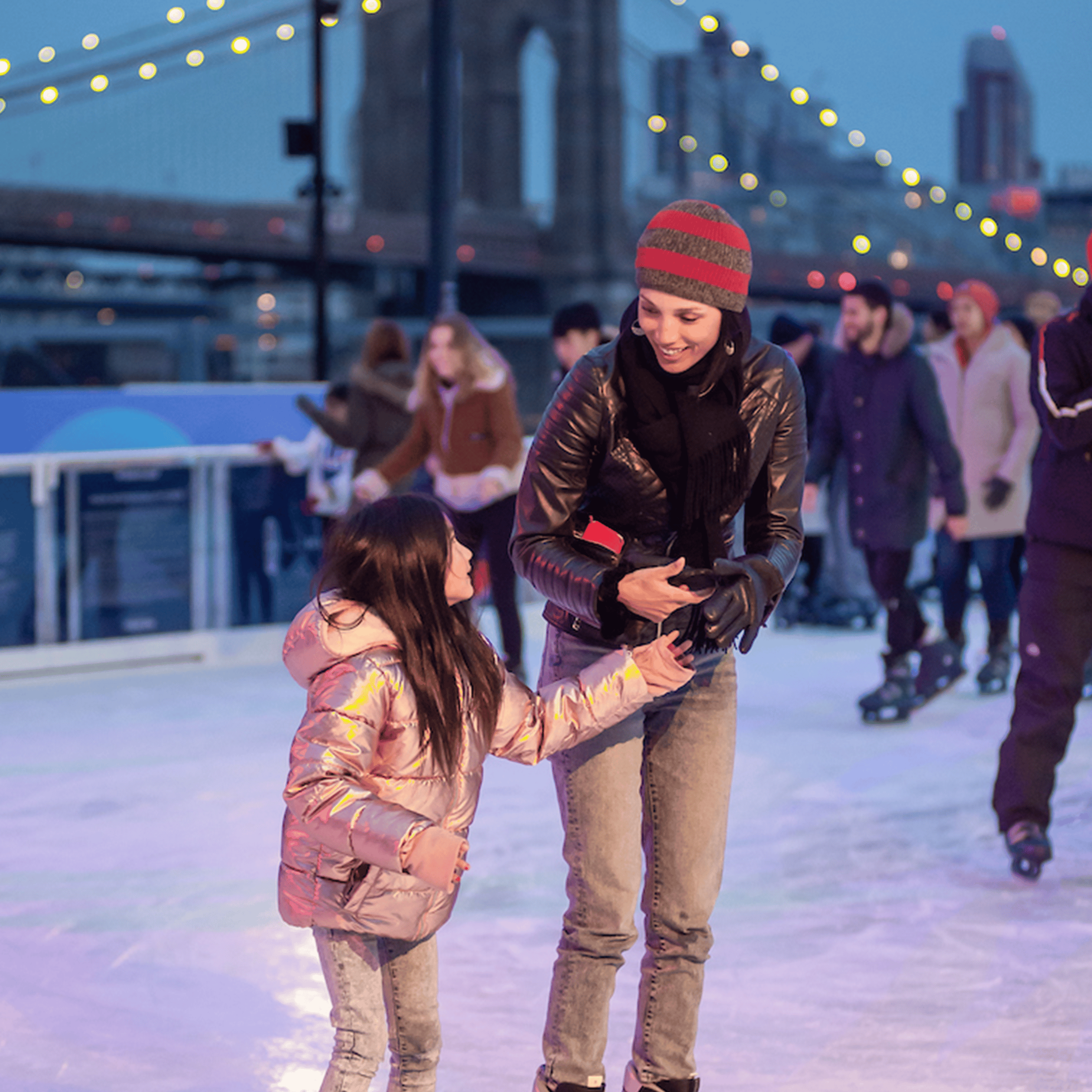 family skating at the ice rink on Pier 17