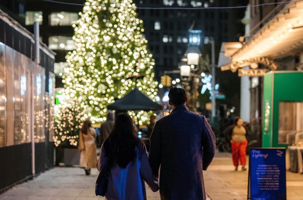 couple heading towards the Christmas tree in the Seaport