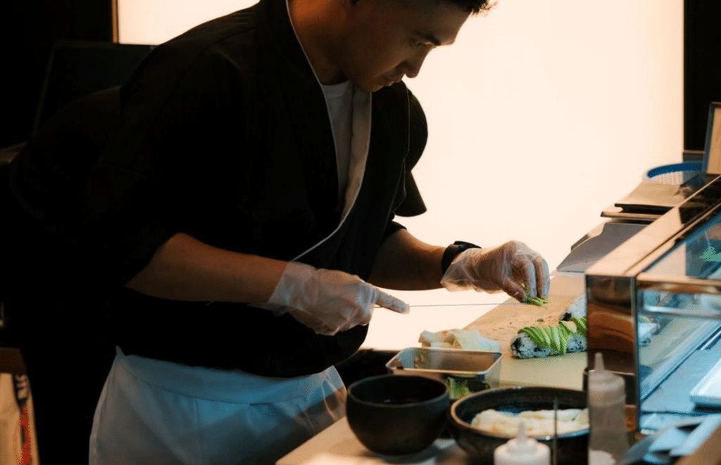 Sushi sous-chef preparing food at Tin Building
