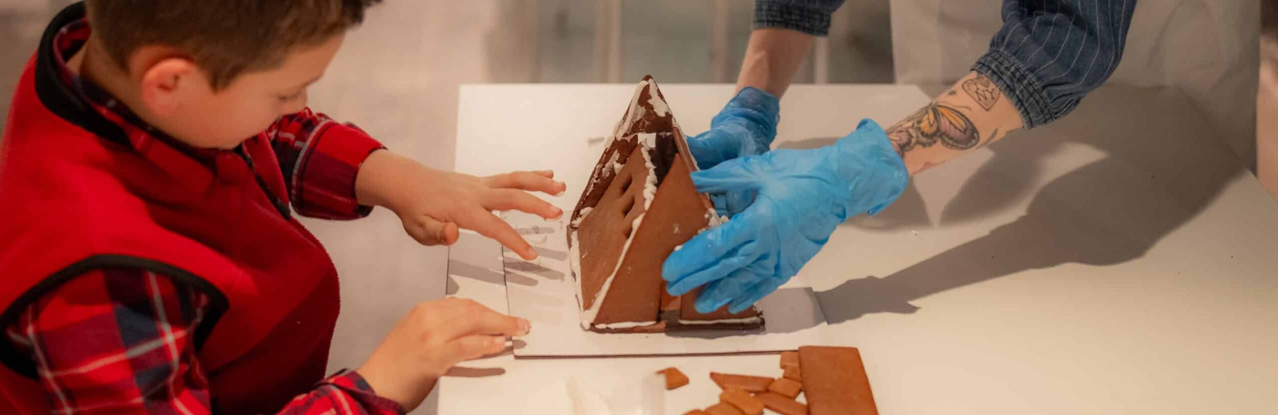 a child builds a gingerbread house at Gingerbread City NYC
