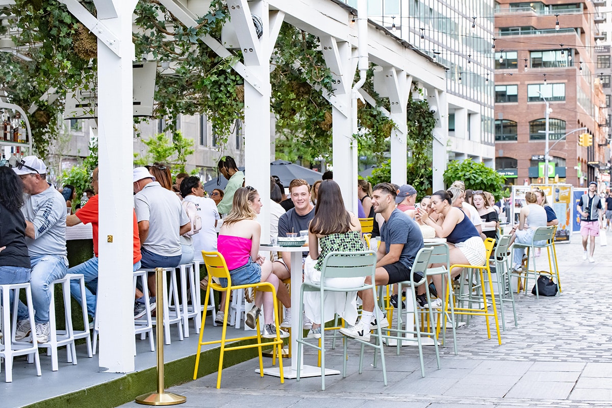 people enjoying sadie's garden bar at the seaport