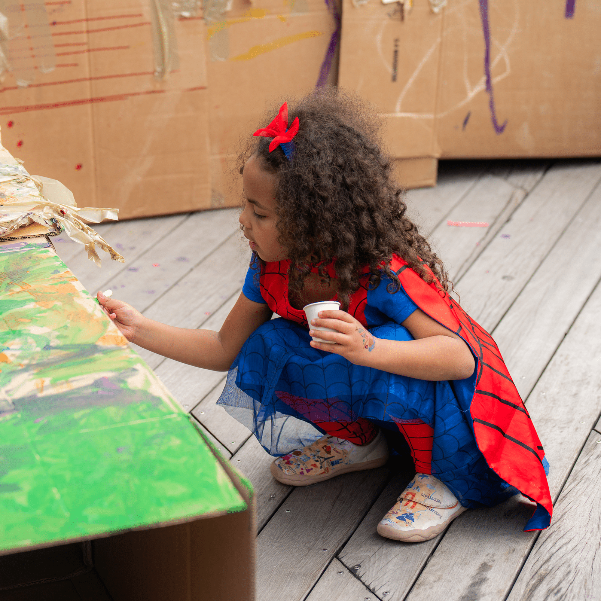 girl in a Spider man costume painting