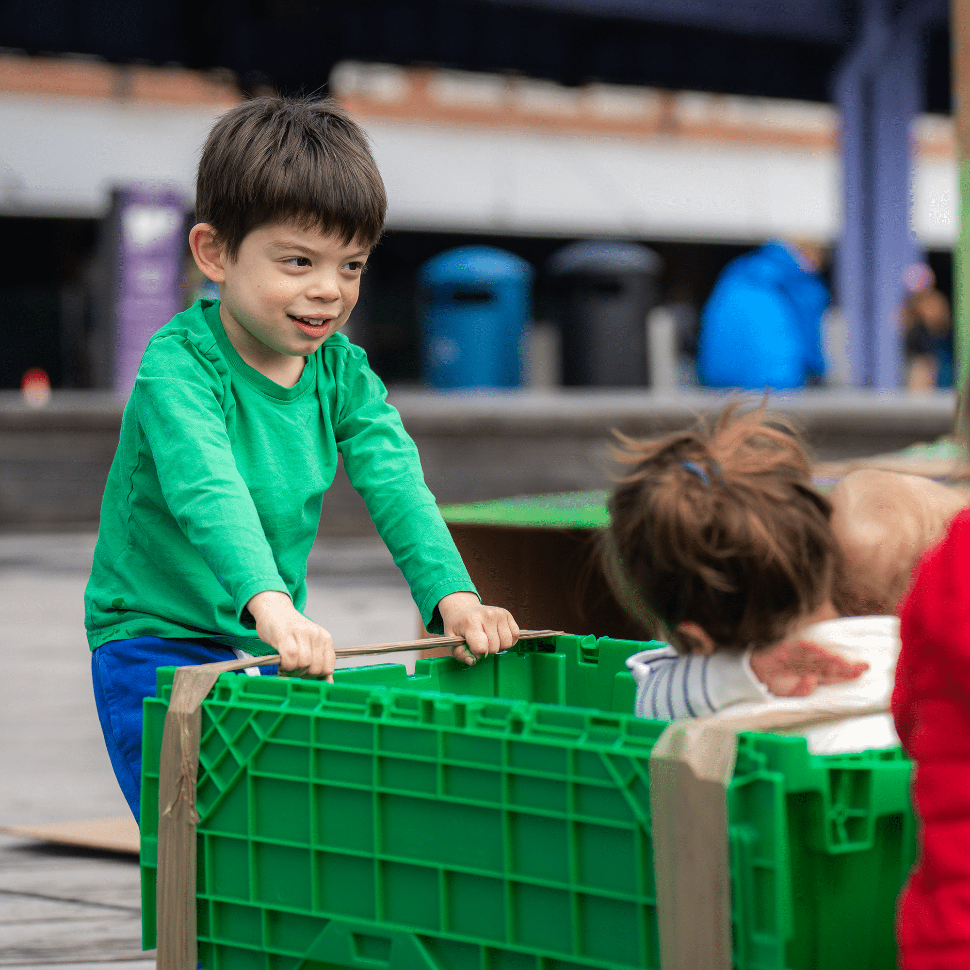 child pushing a trolley at the kids event