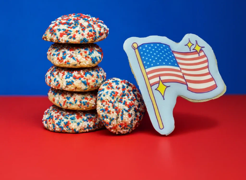 funny face cookies - some with red white and blue sprinkles and one decorated to look like an american flag
