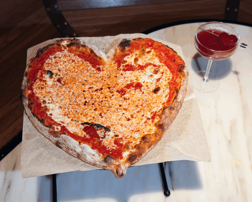 heart shaped pizza at the frenchman's dough in tin building