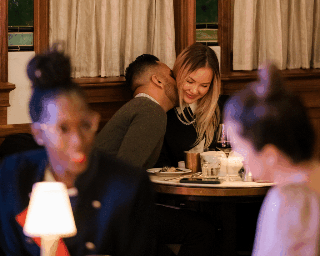 a couple kiss at T.Brasserie in Tin Building
