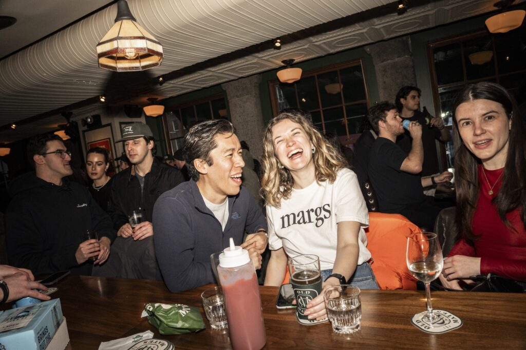a couple laugh at the bar at old mates